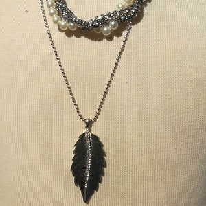 May include: A set of three ceramic mugs with a speckled, matte finish. The mugs are in shades of cream, light gray, and dark gray. Each mug has a simple, minimalist design, perfect for coffee or tea.