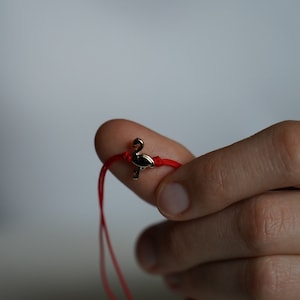Dainty Flamingo - adjustable red yarn bracelet with golden flamingo detail