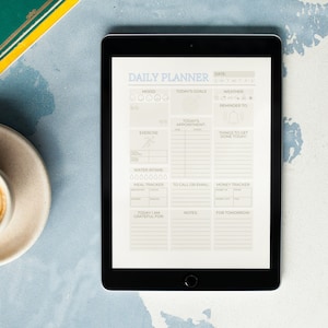 May include: A daily planner app on a tablet screen. The app has sections for mood, today's goals, weather, reminders, appointments, things to get done today, water intake, meal tracker, to call or email, money tracker, today I am grateful for, notes, and for tomorrow.
