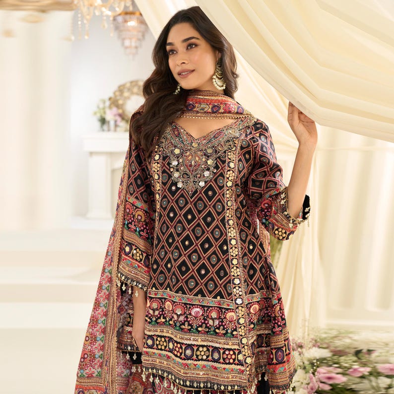 Close-up detail of the intricate Aari embroidery and gota patti work on the black kurta.