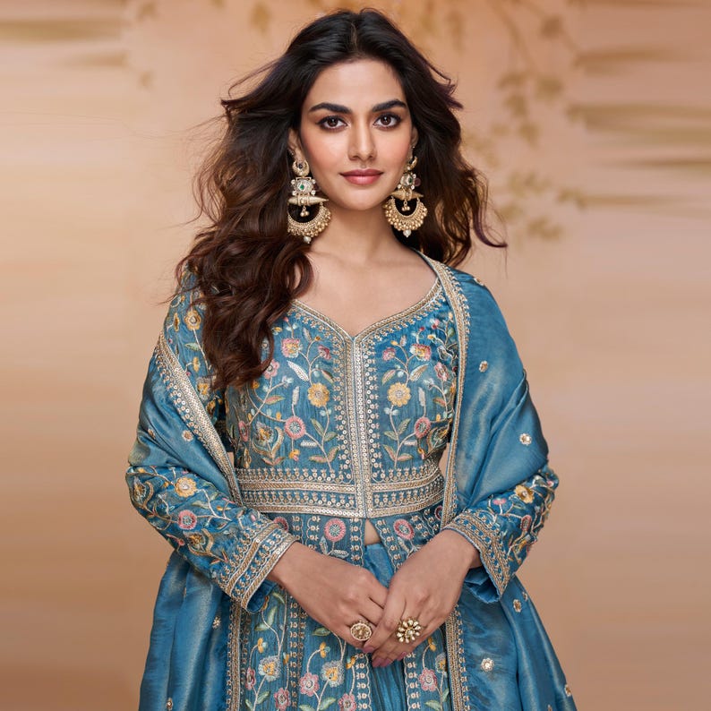 Close-up of beads embroidery work and stone handwork on vibrant turquoise Simar silk fabric