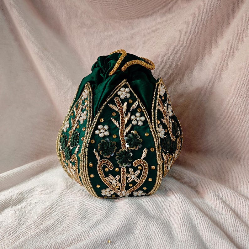 Close-up view of the intricate Zardozi threadwork on the green lotus motif of this Indian bridal purse.