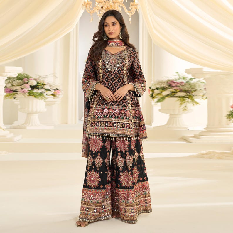 Front view of a black and gold crepe silk kurta palazzo set worn by a model.