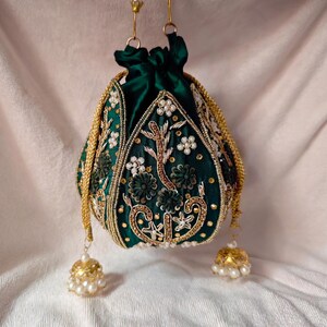 Close-up of the drawstring closure on the green silk potli bag, a key feature of the wedding potli bag design.
