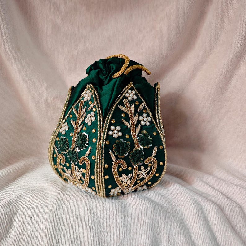 The lotus potli bag paired with a modern indo-western dress, showing its versatility as an evening clutch.