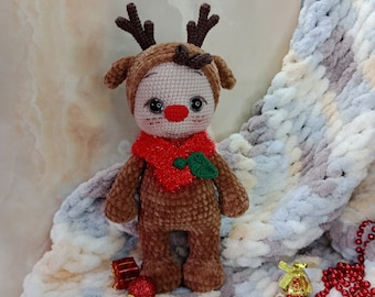 Crochet plush Christmas reindeer baby. Handmade. Interior decoration for Christmas.
