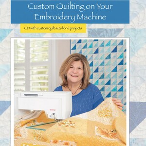 May include: A woman is using an embroidery machine to quilt a yellow and white quilt with a bee pattern. The quilt is on a table in front of her. The title "Custom Quilting on Your Embroidery Machine" is at the top of the image. The text "CD with custom quilt sets for 6 projects" is below the title. The text "AMÉLIE SCOTT DESIGNS" is at the bottom of the image.