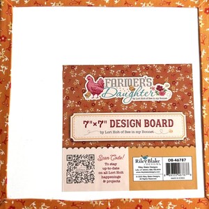 May include: A 7-inch by 7-inch square design board by Lori Holt of Bee in my Bonnet. The board features a white center and a border with an orange floral pattern. The label includes the text Farmer's Daughter, a QR code, and a barcode.