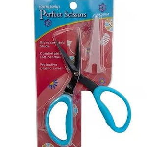 May include: A pair of blue handled scissors with a black blade. The scissors are packaged on a pink and white card with the text "Perfect Scissors" in black. The card also has a small plastic cover for the blade.
