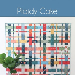 May include: A quilting pattern called "Plaidy Cake" featuring a colorful patchwork quilt with a plaid design. The quilt is made with a variety of fabrics in red, blue, green, yellow, and white. The pattern is available in 5 sizes. The text "Cluck Cluck Sew" is also visible in the image.