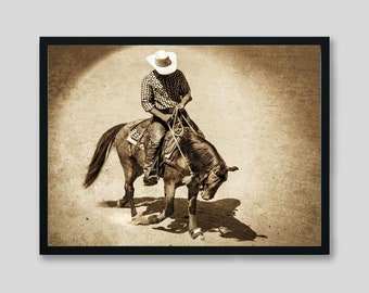 May include: A cowboy in a white hat and plaid shirt rides a brown horse in a sepia-toned photograph.