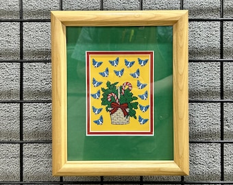 Arte enmarcado de cesta de bastones de caramelo navideños de Blue Dog - Estilo George Rodrigue