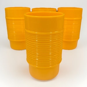 May include: Four vibrant orange plastic tumblers. Each tumbler features a ridged pattern around the middle and smooth top and bottom sections. The cups are grouped together, with one in front and the others behind.