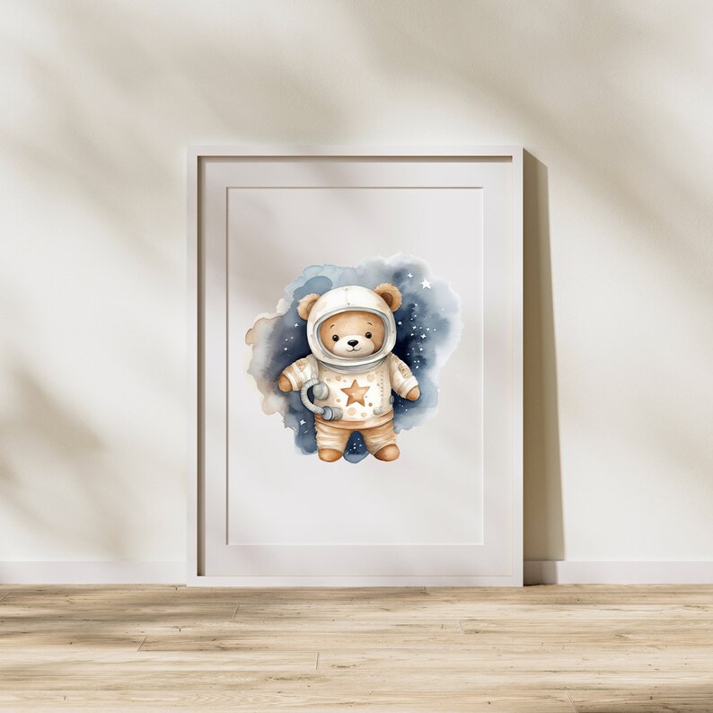 May include: A watercolor illustration of a brown teddy bear wearing an astronaut suit with a star on the chest. The bear is standing in a blue and white watercolor galaxy background.