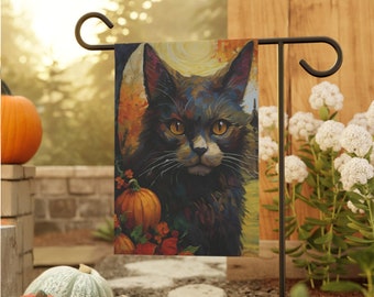 May include: A black cat with yellow eyes is featured on a fall-themed garden flag. The flag is a dark blue color with orange pumpkins and red flowers. The cat is looking directly at the viewer.
