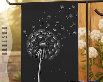 May include: Black garden flag with a white dandelion design. The dandelion is blowing seeds in the wind. The flag is double-sided and has the text "2 Sizes Available" and "Made in USA".