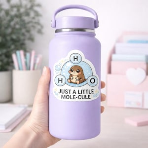 May include: A light purple water bottle with a silver cap and handle. A sticker on the bottle features a cartoon mole inside a water molecule design, with the text "JUST A LITTLE MOLE-CULE".