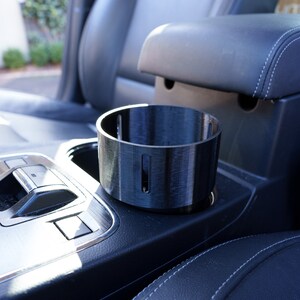This is our new V2 Cup Holder adaptor for Frank Green 1000ml drink bottles and the YETI Rambler 36oz drink bottles. The slotted holes in the side reduce suction so you don't have the adaptor come out with the bottle when you want a drink.