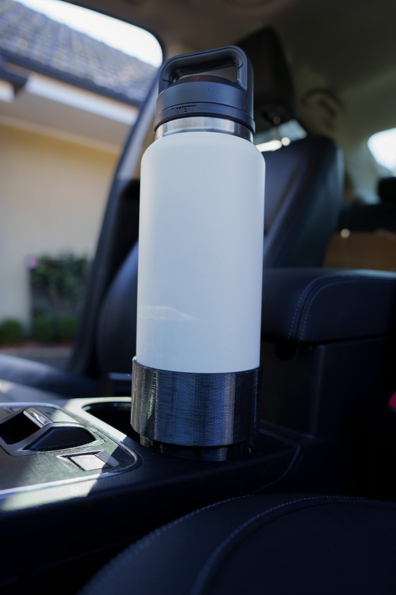 This is the YETI Rambler Cup Holder Adapter with a YETI Rambler 36oz (1065ml) drink bottle inside it. This was our V1 model, the new V2 is updated to fit both the Frank Green and YETI Rambler drink bottles with reduced suction.