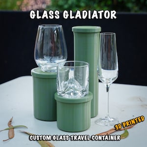 May include: Three 3D printed green travel containers for glasses. The containers are designed to protect glasses while traveling. The text "GLASS GLADIATOR" and "CUSTOM GLASS TRAVEL CONTAINER" are visible in the image. The text "3D PRINTED" is in a yellow box.