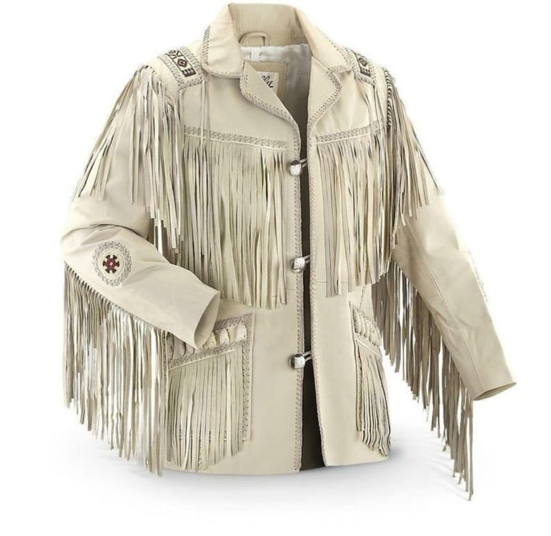 May include: A cream-coloured leather jacket with long fringe detailing on the sleeves, chest, and back. The jacket features decorative stitching and silver-tone button closures. The sleeves have embroidered accents, adding a unique touch to this western-inspired outerwear.