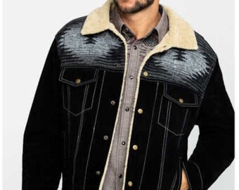 May include: Black denim jacket with a cream-colored sherpa collar and a patterned yoke. The jacket has gold-colored buttons and white stitching. The model is wearing a button-down shirt and blue jeans.