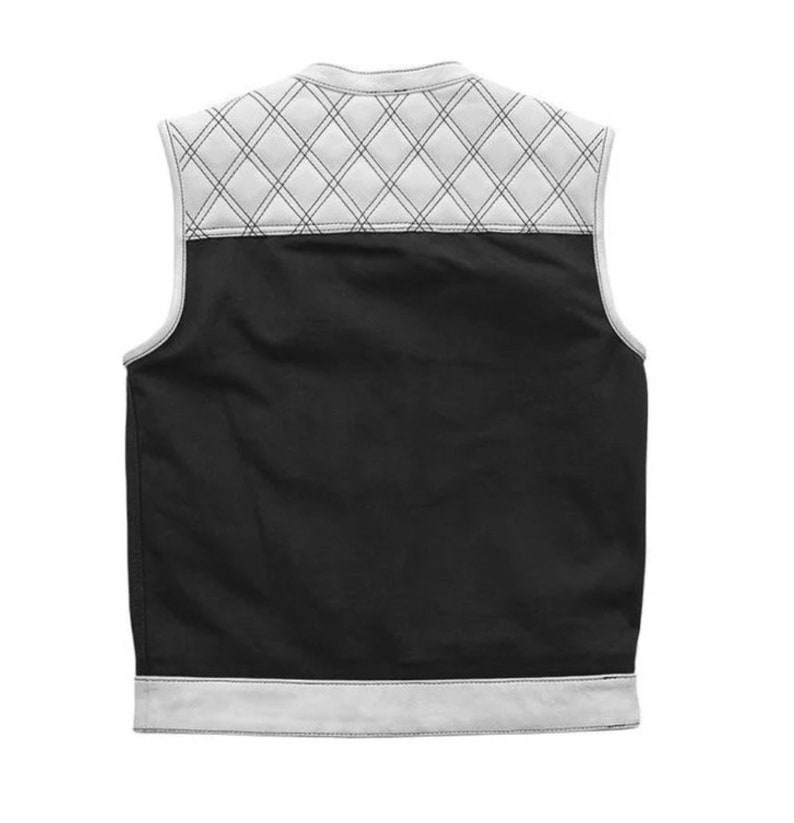 May include: Black vest with a white quilted diamond pattern on the upper back and white trim. The vest is sleeveless and has a classic design, suitable for layering. The back of the vest is shown against a white background.