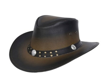 May include: A brown and black cowboy hat with a wide brim. The hat features a decorative band with silver-colored studs and two silver-colored medallions. The hat has a leather appearance and is suitable for outdoor wear.
