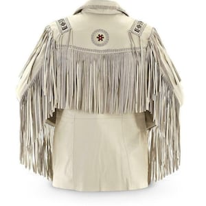May include: Cream leather jacket with long fringe detailing on the back and sleeves. The jacket has decorative stitching and a circular design with red accents on the upper back. A classic western-inspired garment.