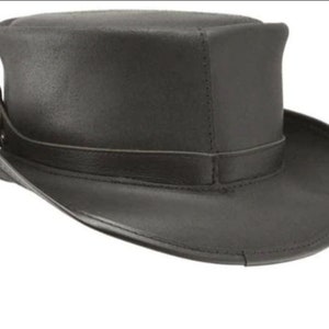 May include: A black leather top hat with a wide brim and a band around the crown. The hat has a structured shape and a slightly textured surface. The hat is a classic style, suitable for formal events or costume wear.