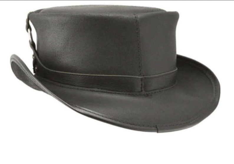 May include: A black leather top hat with a wide brim and a band around the crown. The hat has a structured shape and a slightly textured surface. The hat is a classic style, suitable for formal events or costume wear.