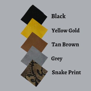May include: Fabric swatches in a range of colours and textures, including black, yellow gold, tan brown, grey, and a snake print. Each square swatch has its colour name beside it. Ideal for craft projects or design inspiration.