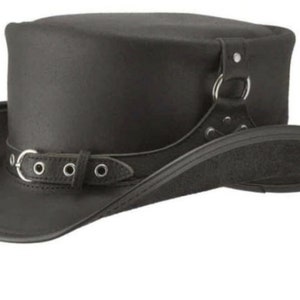 May include: Black leather top hat with a wide brim and a cylindrical crown. The hat features a decorative strap with a buckle and metal ring detail. The hat is a classic accessory.