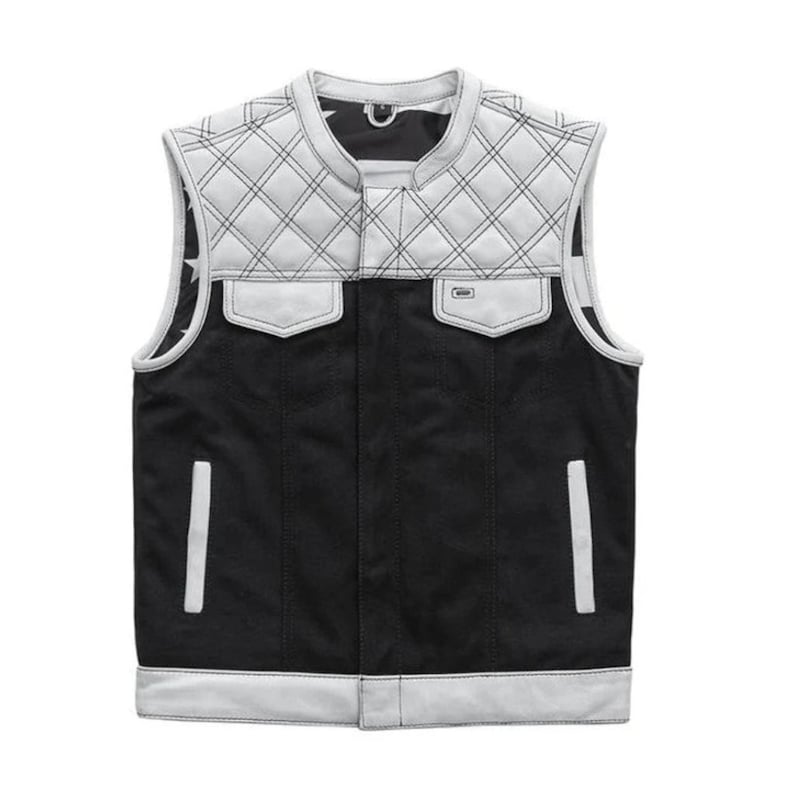 May include: A black and white vest with a quilted design on the shoulders and upper chest. The vest has two front pockets and a white trim. The interior lining features a star pattern. The vest is sleeveless and has a classic, rugged style.