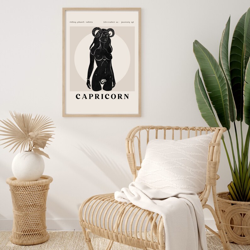 May include: A black and white illustration of a woman with horns, representing the zodiac sign Capricorn. The illustration is on a beige background with the word "CAPRICORN" printed below it.