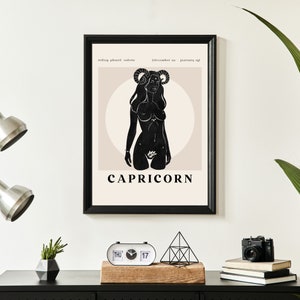 May include: A black and white illustration of a Capricorn zodiac sign with the text "CAPRICORN" below. The illustration is a silhouette of a woman with horns and a flower in her hand. The background is a light beige color with a circle around the woman.