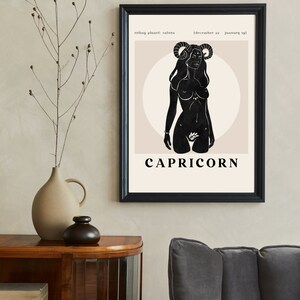 May include: A black and white illustration of a woman with horns, representing the zodiac sign Capricorn. The text "Capricorn" is below the illustration, and the text "ruling planet: saturn (december 22 - january 19)" is above the illustration.