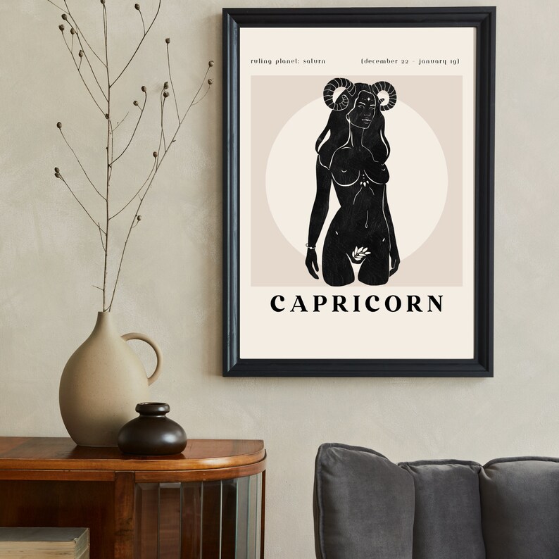 May include: A black and white illustration of a woman with horns, representing the zodiac sign Capricorn. The text "Capricorn" is below the illustration, and the text "ruling planet: saturn (december 22 - january 19)" is above the illustration.