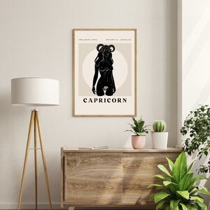 May include: Black and white illustration of a Capricorn zodiac sign. The illustration features a woman with horns and a goat tail. The text "CAPRICORN" is below the illustration.
