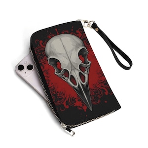 Cartera de calavera de cuervo, gótica y espeluznante, con correa de muñeca extraíble, estilo macabro y oscuro.