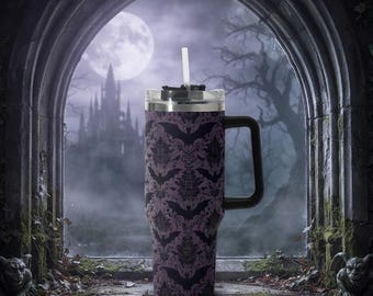 May include: A stainless steel tumbler with a handle and a clear lid featuring a white straw. The exterior surface is decorated with a repeating damask pattern in shades of black and muted purple, incorporating silhouettes of flying bats.