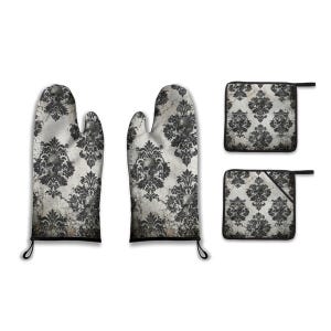 May include: A kitchen set featuring two oven mitts and two pot holders. The set has a gothic design with a skull and damask pattern in black and gray on a white background. The oven mitts have black trim and hanging loops.