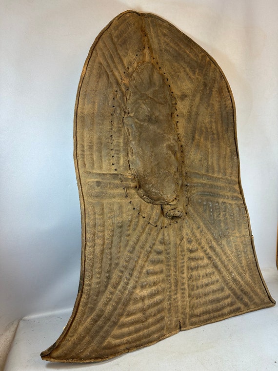 Embossed Metal Kirdi Shield from Cameroon on Bronze Stand Embossed Metal Kirdi Shield from Cameroon on Bronze Stand