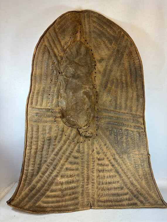 Embossed Metal Kirdi Shield from Cameroon on Bronze Stand Embossed Metal Kirdi Shield from Cameroon on Bronze Stand