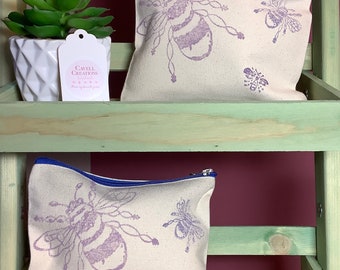 Handprinted cotton zipped pouches/cosmetic bags with lilac bee design.