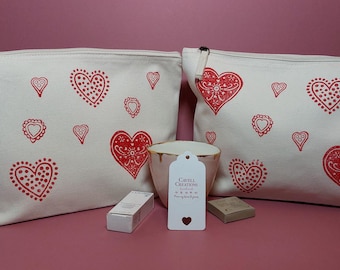 Handprinted organic cotton zipped pouch/toiletry/cosmetic bag with red hearts.