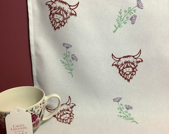 Handprinted cotton tea towel with highland cow design.