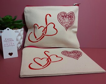 Handprinted cotton canvas zipped pouch/cosmetic bag with red multi heart design.