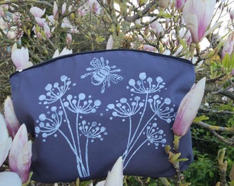 Grey and white zipped pouch/cosmetic bag with seed head and bee design.