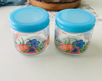 Par de pequeños recipientes de vidrio vintage con diseño de flor azul